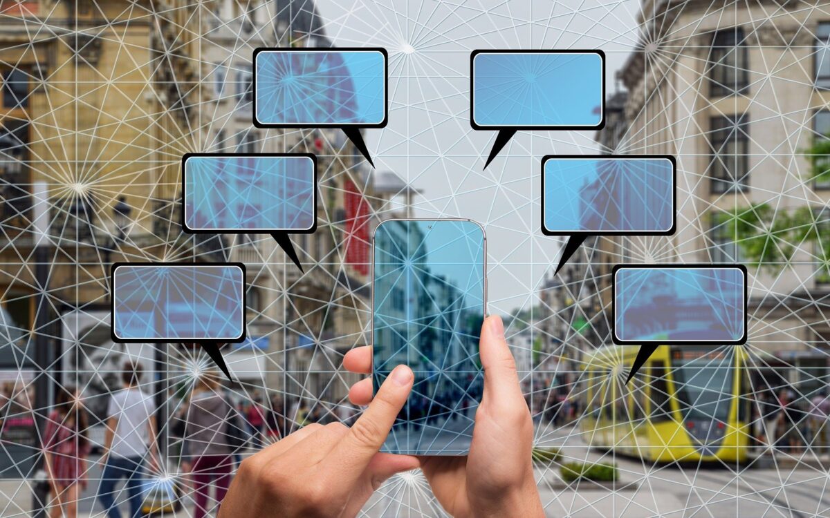 Smartphone connectivity in urban environment with speech bubbles.